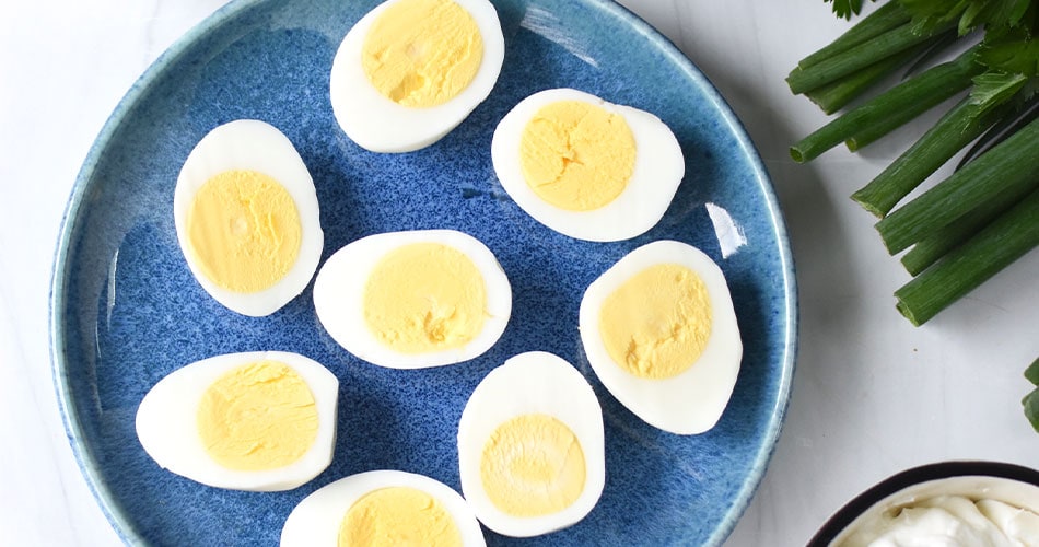 Hard bioled eggs halved on a plate