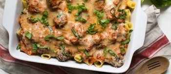 Baked Rigatoni Pasta with Spinach and Meatballs in a pan