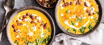 Two bowls of creamy red lentil butternut squash soup