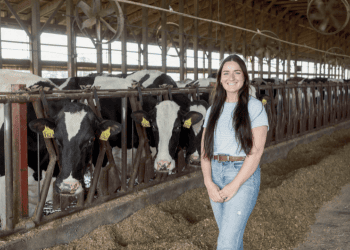Meagan Hempfling standing in front of cows.