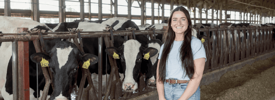 Meagan Hempfling standing in front of cows.