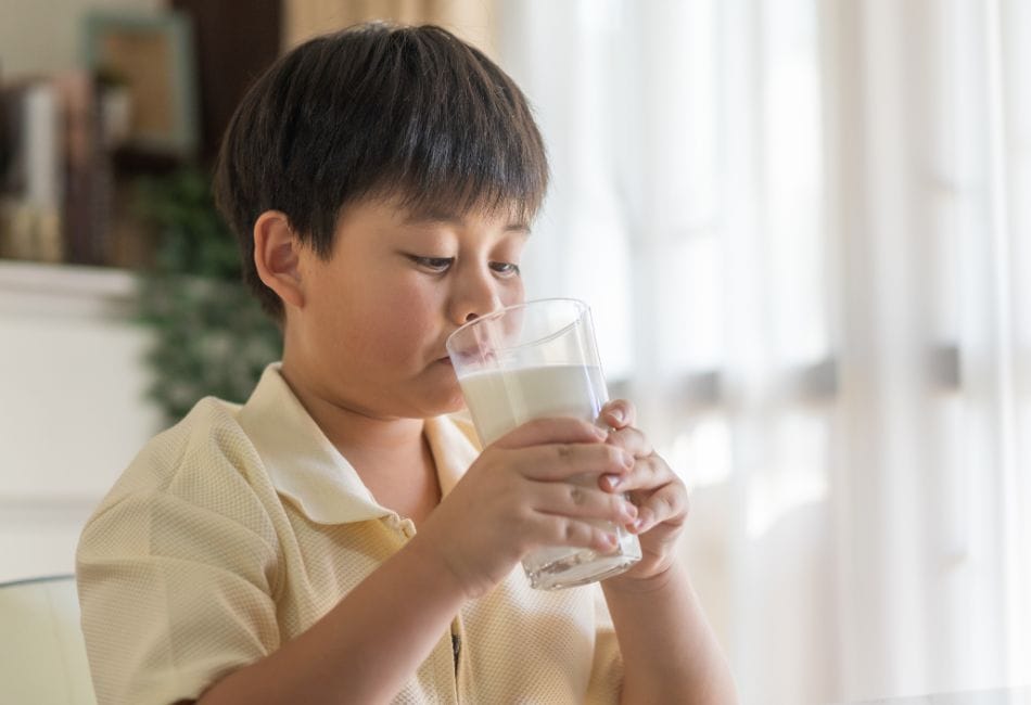 Young Asian Child Drinking Milk