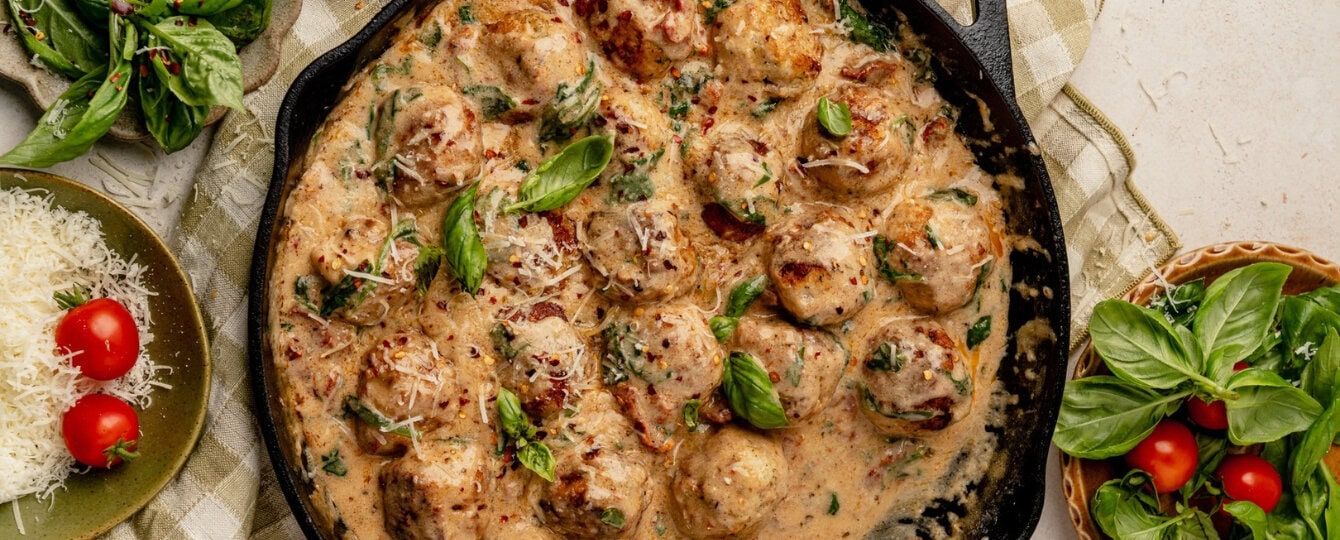 Close up of marry me chicken meatballs in a cast iron skillet